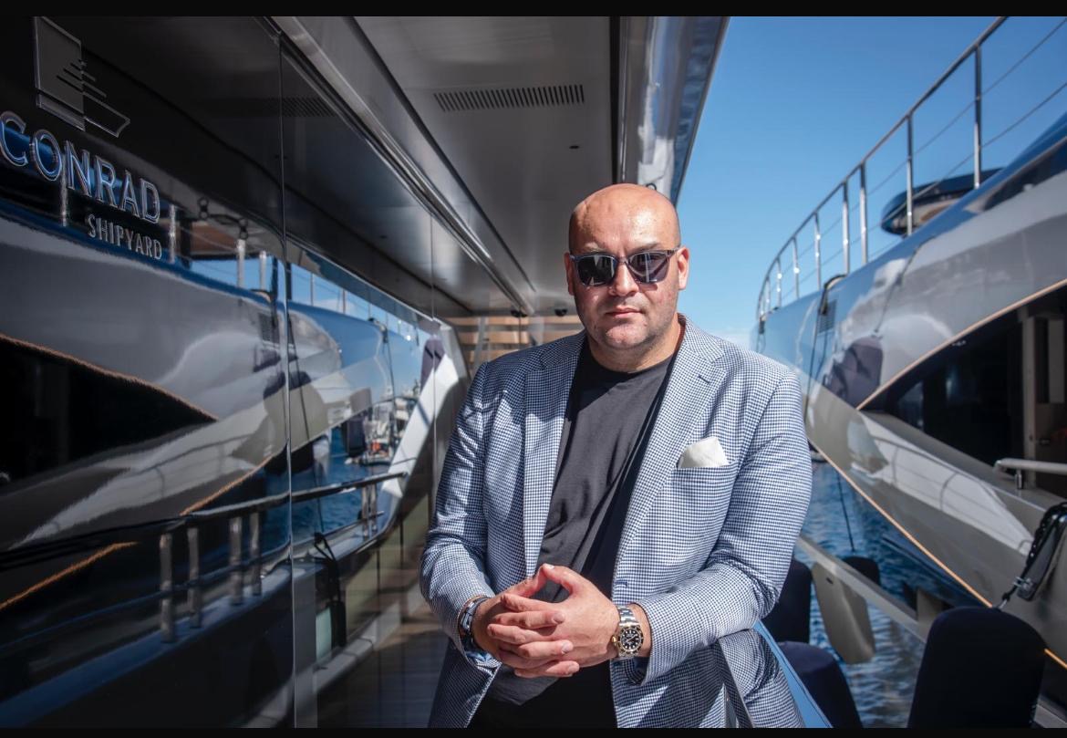 Ali standing alone aboard a yacht
